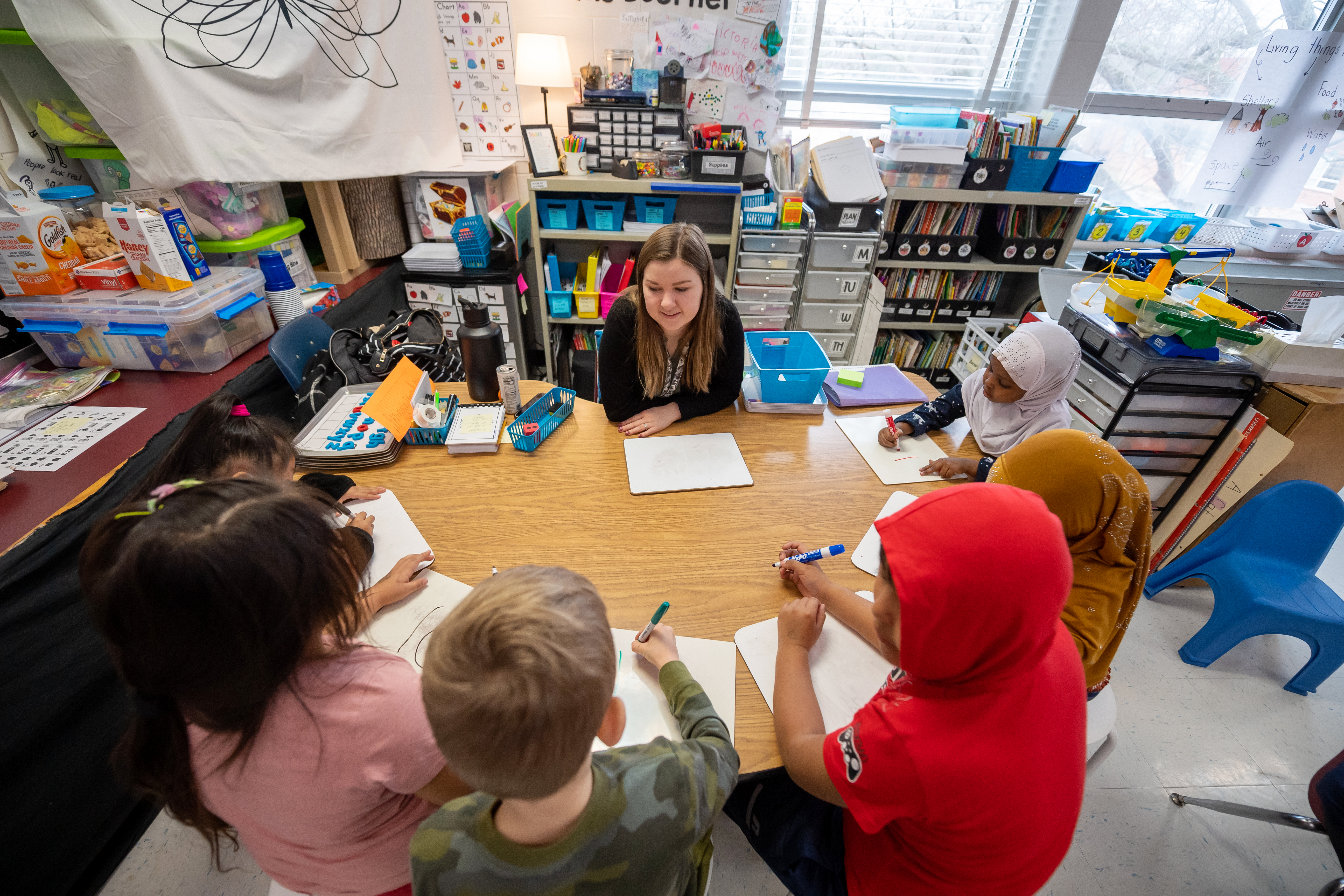 Mrs. Tracey working with Kindergarten students in a small group. 